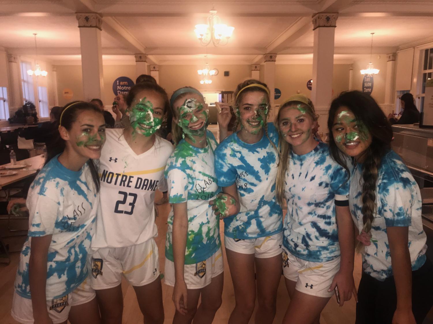 Kearney (second from right) and her teammates celebrate the last league game of the season.