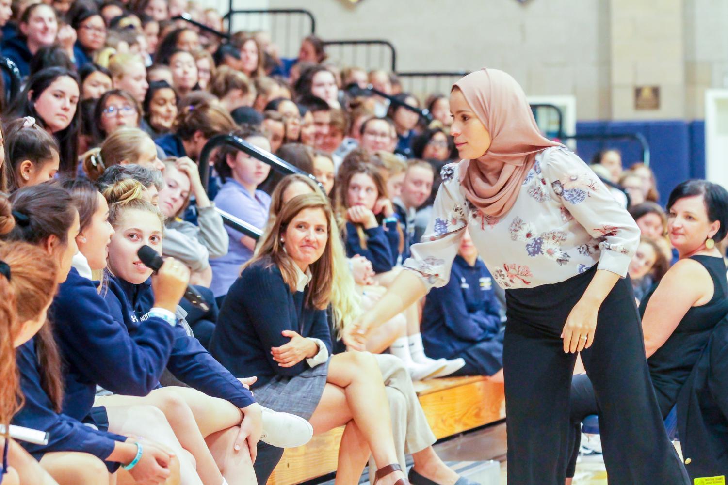 Dr. Alaa Murabit facilitates a discussion with students during a whole school assembly.