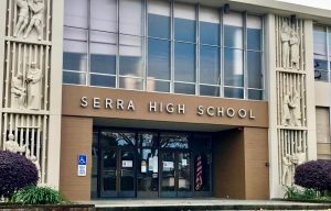 COVID-19 restrictions hang from the 20th Avenue Doors of Serra HS.