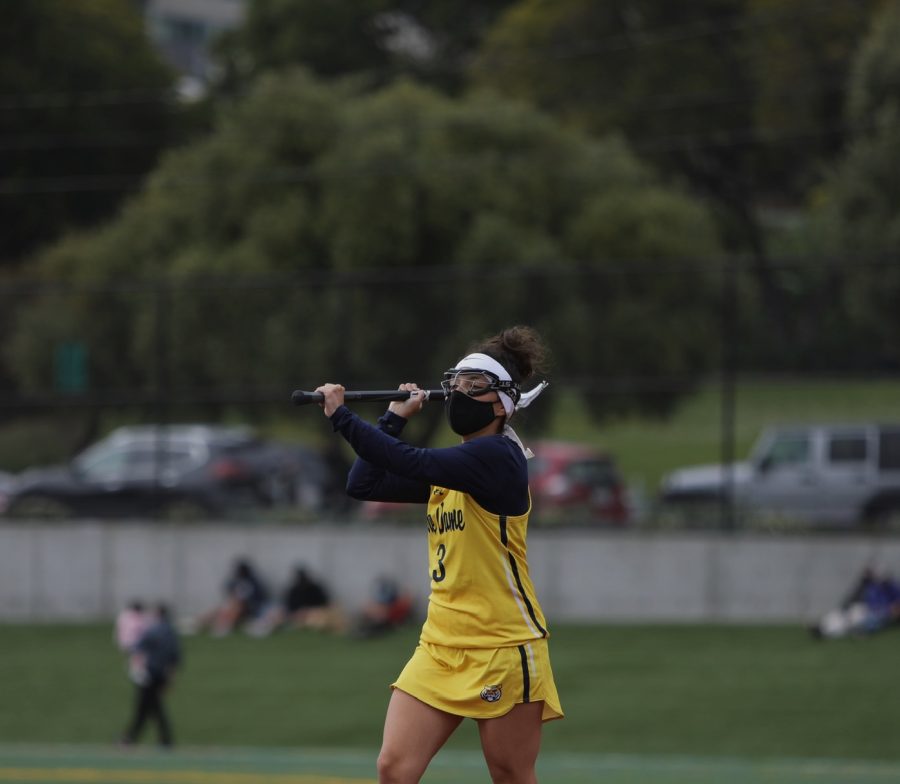 Aquino passes the ball to her teammate during the lacrosse game at James Lang Field against Sacred Heart Cathedral on April 23rd.
