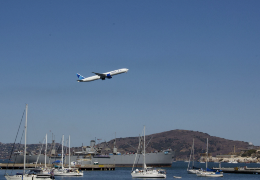United Boeing 777 flying past the marina.