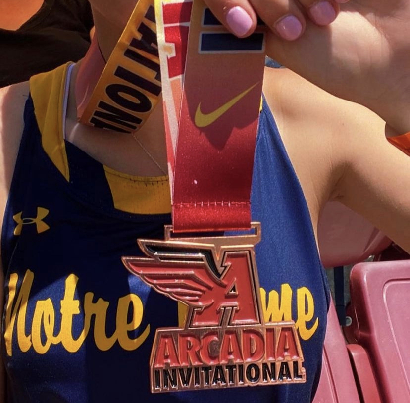 Melanie Castelli poses with her medal after she wins 3rd place in high jump at one of the most competitive track meets in the nation.