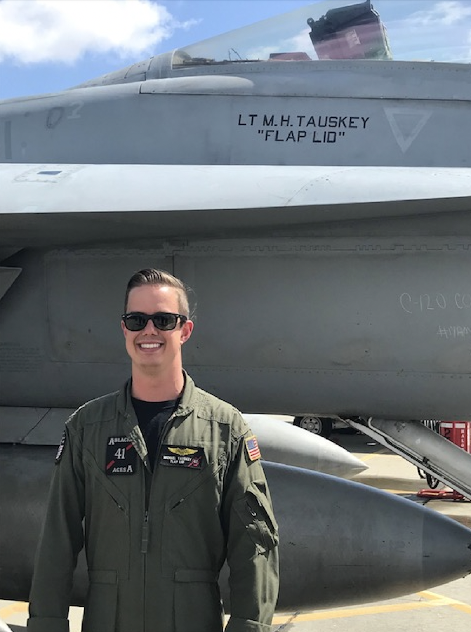 Michael Tauskey poses in front of his naval jet.