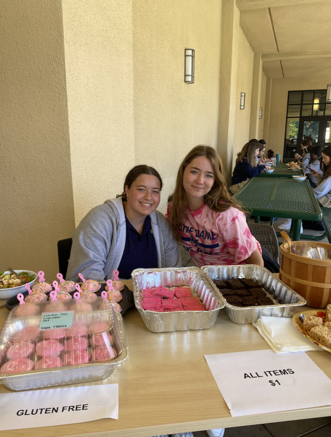 Abigail Edelhart and Francesca Arbelaez selling treats for the Dig Pink bake sale in support of breast cancer awareness.