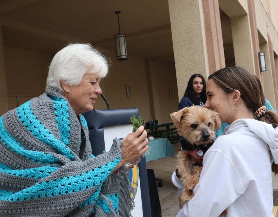 Senior Kayla Hollister gets her dog blessed.