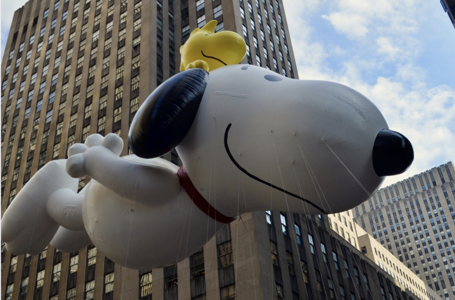 A Snoopy balloon floats through the sky at the Macy’s Thanksgiving Day Parade.