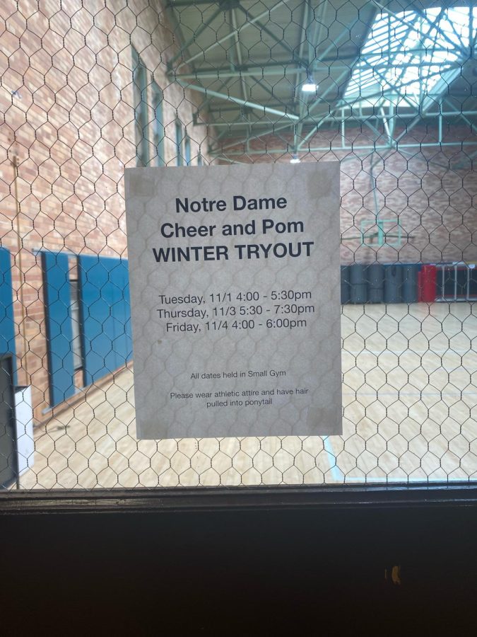 NDB Spirit Squad coaches pin up flyers announcing the new winter tryouts.