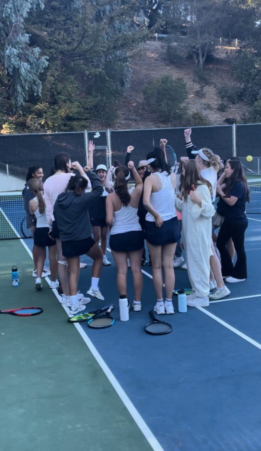 Tennis team comes together for a final team cheer before Senior Day.