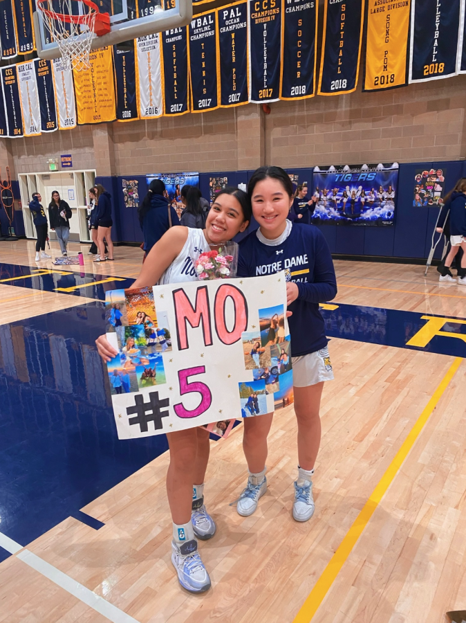 Senior Monique Samson poses with sophomore Sofia Kwan after winning the game.