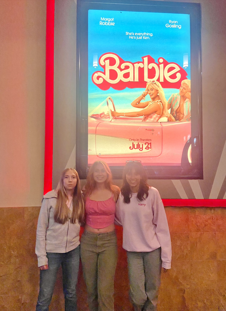 NDB students pose in front of the Barbie poster.