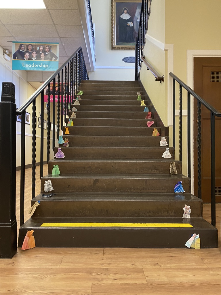 Origami dresses adorn the staircase at NDB