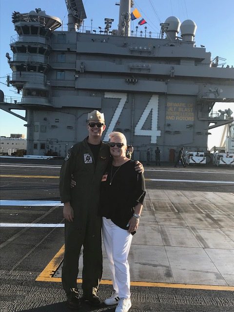 NDB Student Services Advisor Barbara Tauskey with her son in Top Gun, Lt. Michael Tauskey.