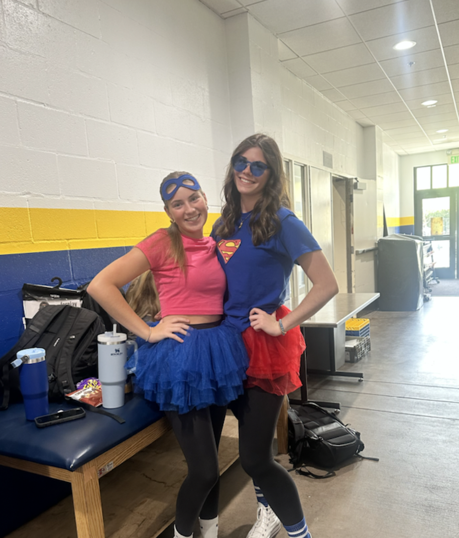 Sophomores Brooke True and Gia Rivera dress up together in a superhero costume.