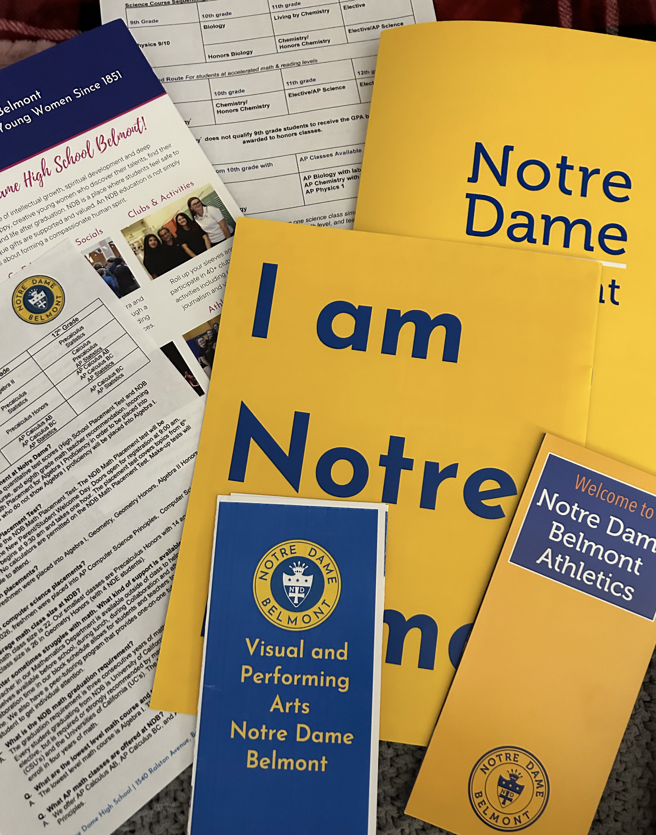Prospective students are given brochures and papers to learn more about what NDB has to offer.