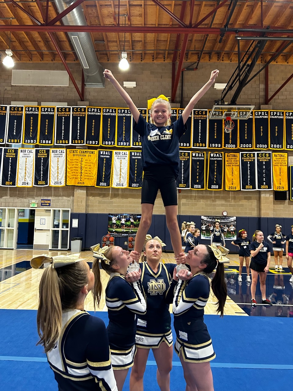 Members of NDBs Varsity Cheer team introduced the middle-schoolers to stunting with demonstrating and rotating preps.