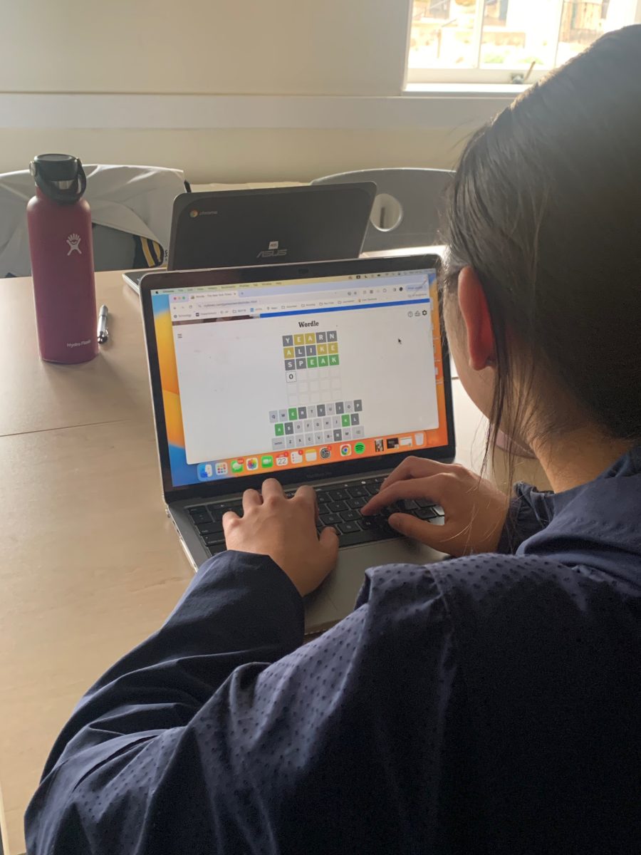 A student plays Wordle, a popular New York Times game, to try and solve a five-letter word in six guesses.