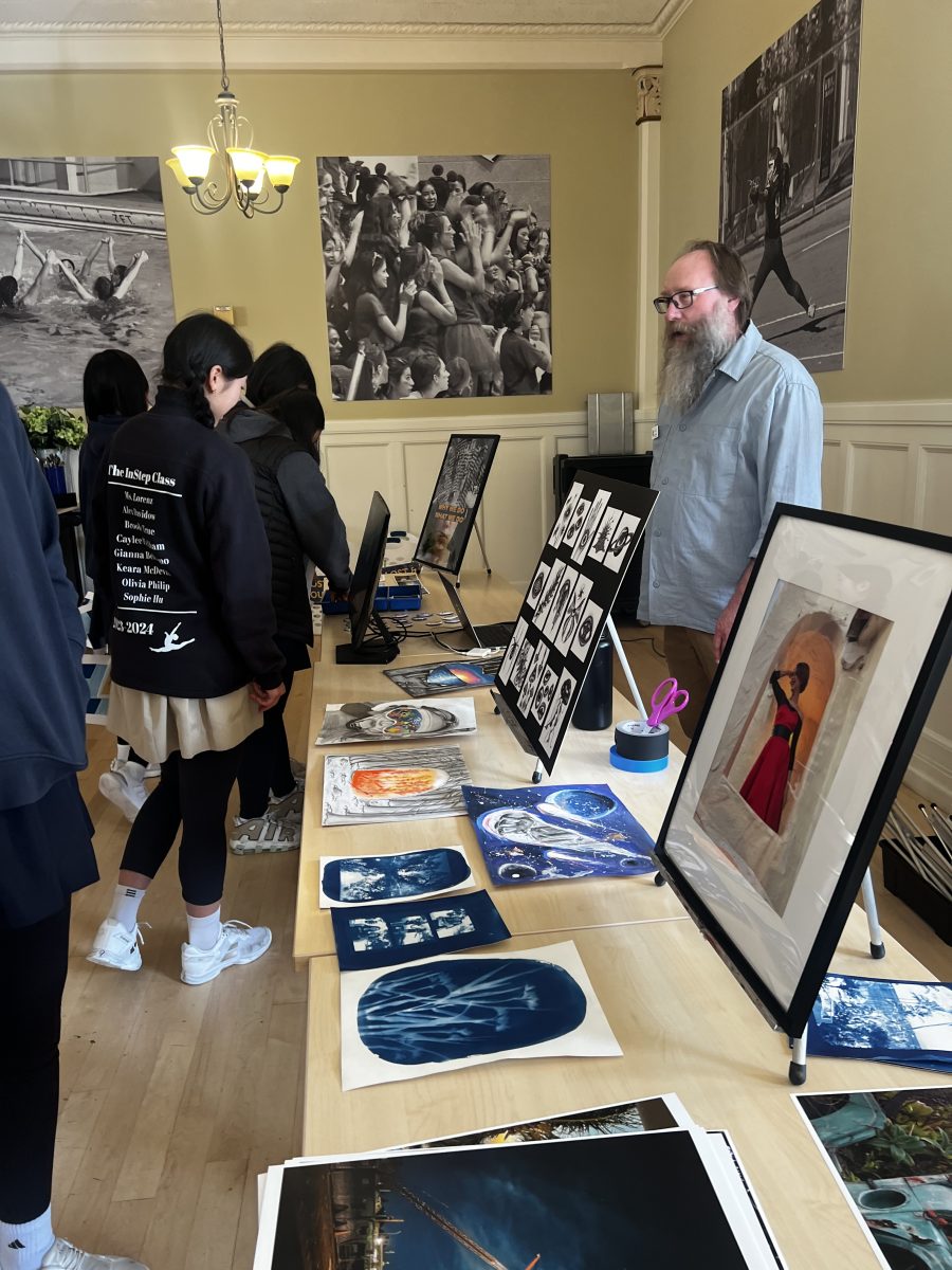 Students interested in Art and Photography electives ask Mark Thiesen about the photos on display.