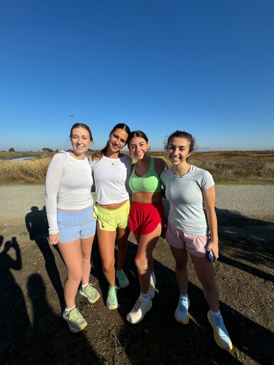 Seniors Annette Henderson, Maddy King and Sabrina Philip pose with Renee Noe (second from left) at her run club in Palo Alto.