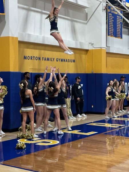 Senior Ashley Strain is thrown in a straight-ride basket toss by her bases Gabby Lonardo and Nikki Guinasso and backspot Kiara Karcich.