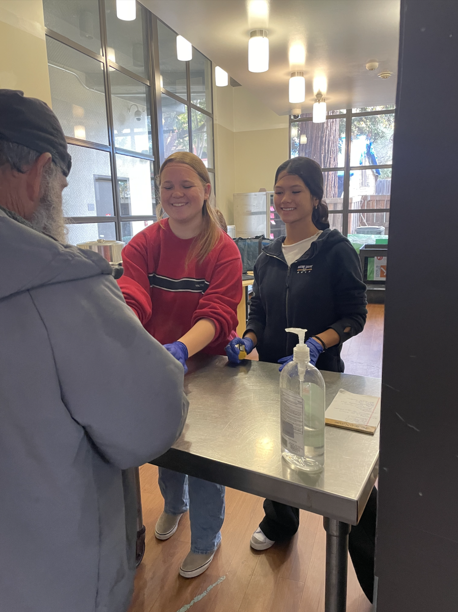 Juniors Claire McCoy and Alexis Hom help serve meals to residents of LifeMoves, an organization that provides interim housing and other necessities to low-income individuals.