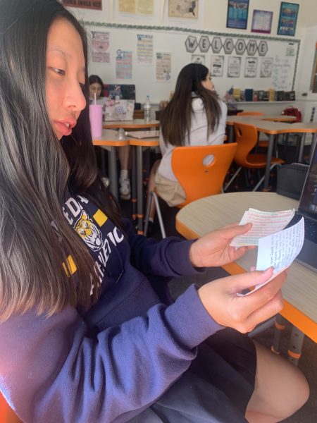 Junior Andie Wong uses flashcards to prepare for her exam on the following day.