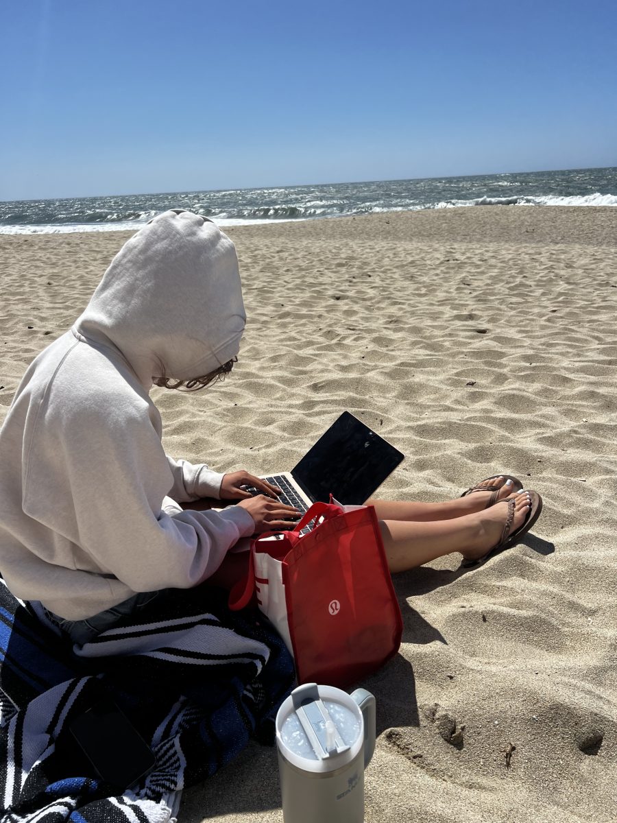 Senior Malaina Alifano brings her computer to the beach with her friends on Senior Ditch Day to work on school work, but also spend her senior holiday with her friends.