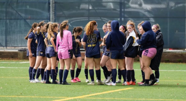 The NDB soccer team huddled together to discuss the game plan. 