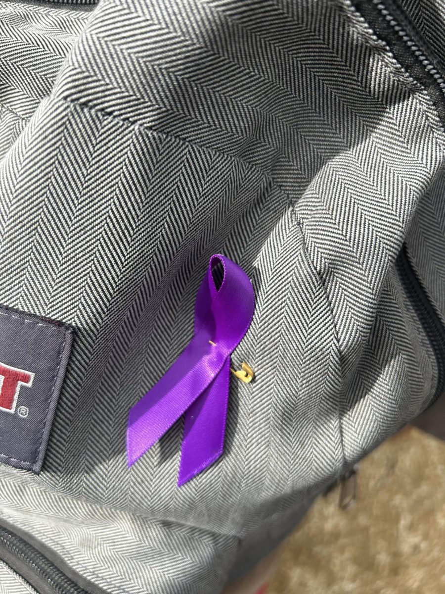 Students rally support for Epilepsy Awareness by pinning a purple ribbon on their backpacks. The ribbon's lavender color is nationally used to recognize Epilepsy.