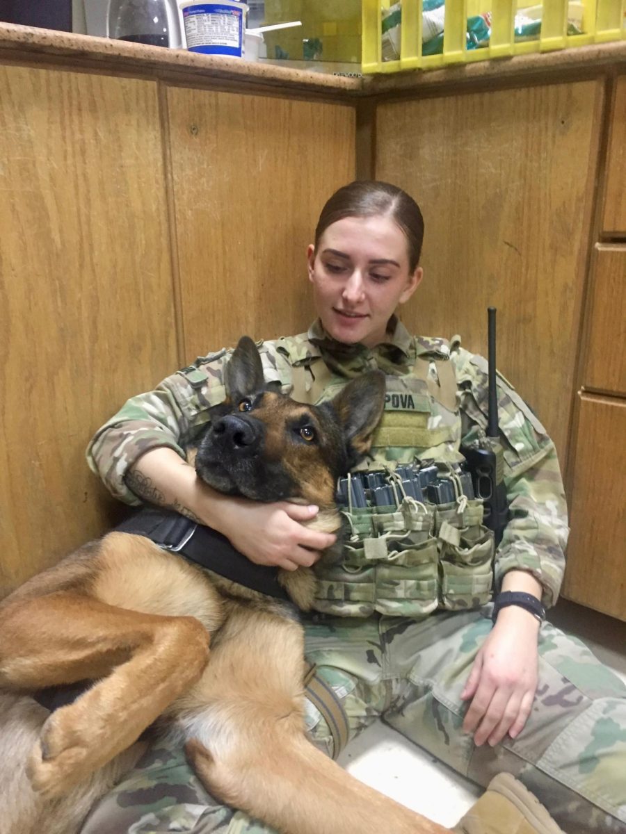 U.S Army soldier Diana Popova poses with her K-9 'Arnost'