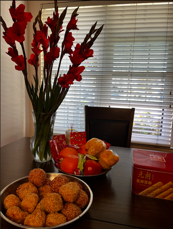 Traditional Lunar New Year snacks and decorations are displayed.