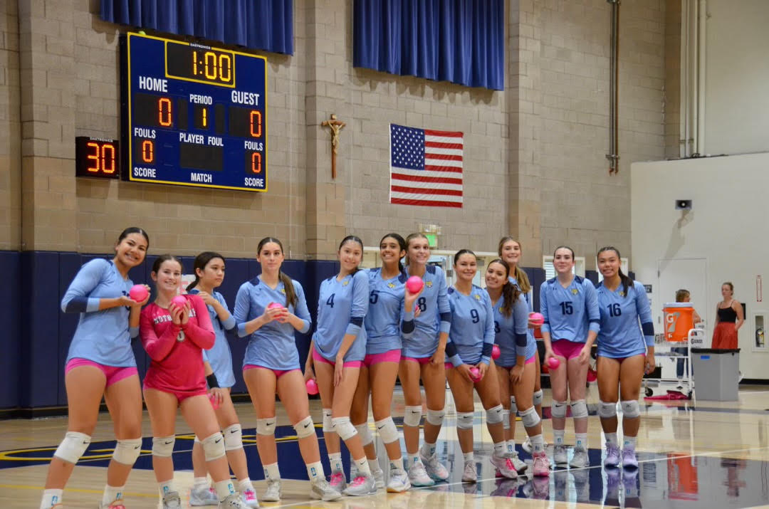 Sophomore Sammy Kakala poses with her team before NDB's annual Dig Pink game. Kakala credits her teammates as her biggest support system that she can turn to for guidance before high-stakes matches. 