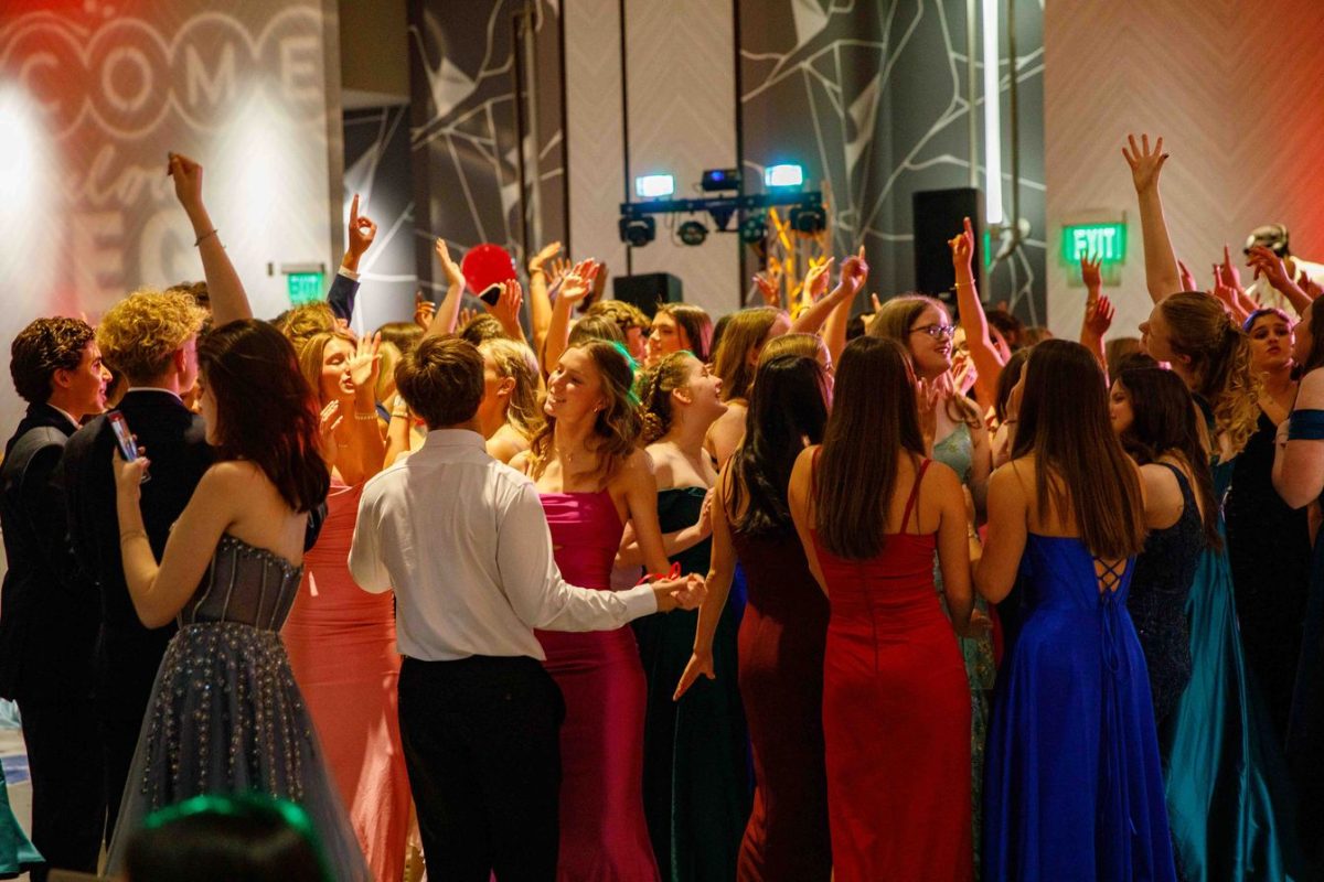 Students enjoy dancing and singing along to the music on the dance floor. 