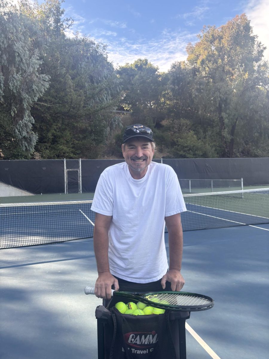 New tennis coach, David Tyler, poses for a photo at CSM tennis courts, the practice location for the team. 