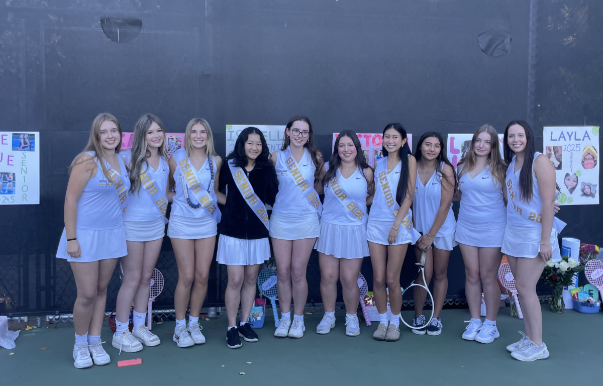Seniors pose together during their final match, marking the end of their tennis journey.