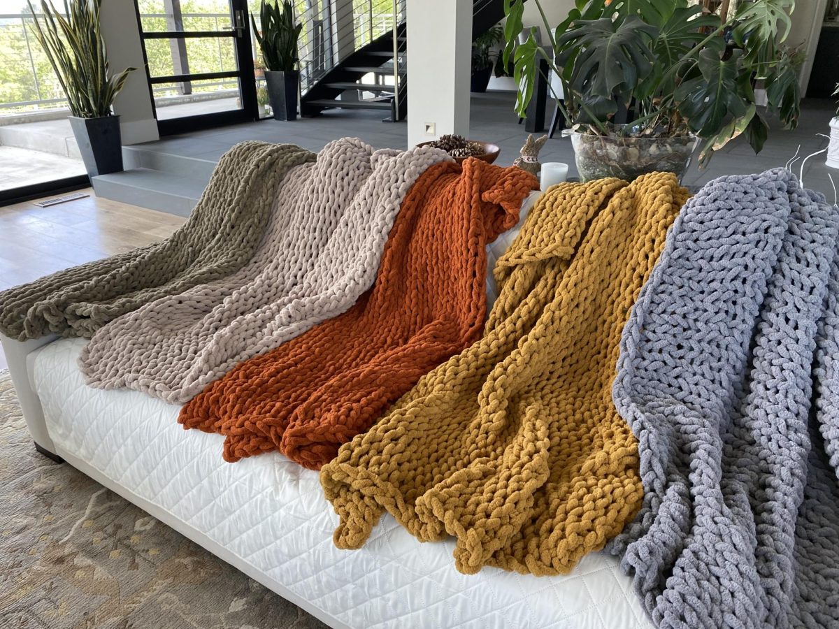Displayed are Guinasso’s colorful, handmade knit blankets.