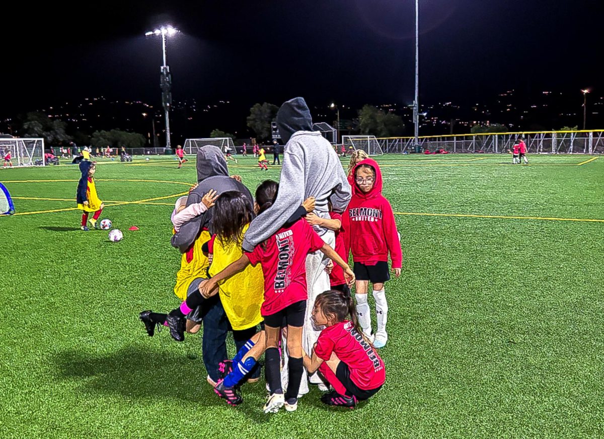 After a game, senior Anna Street celebrates with the kids she mentors on Belmont United.