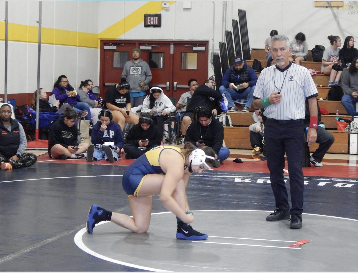 Senior Cat Dorf takes on Woodside in a tough wrestling match. 