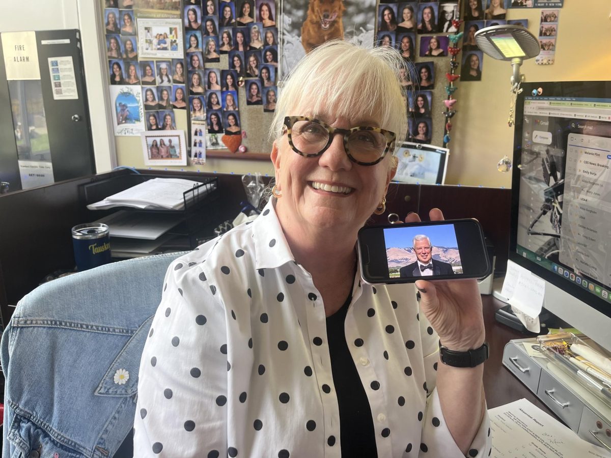 Barbara Tauskey holding a photo of her husband.