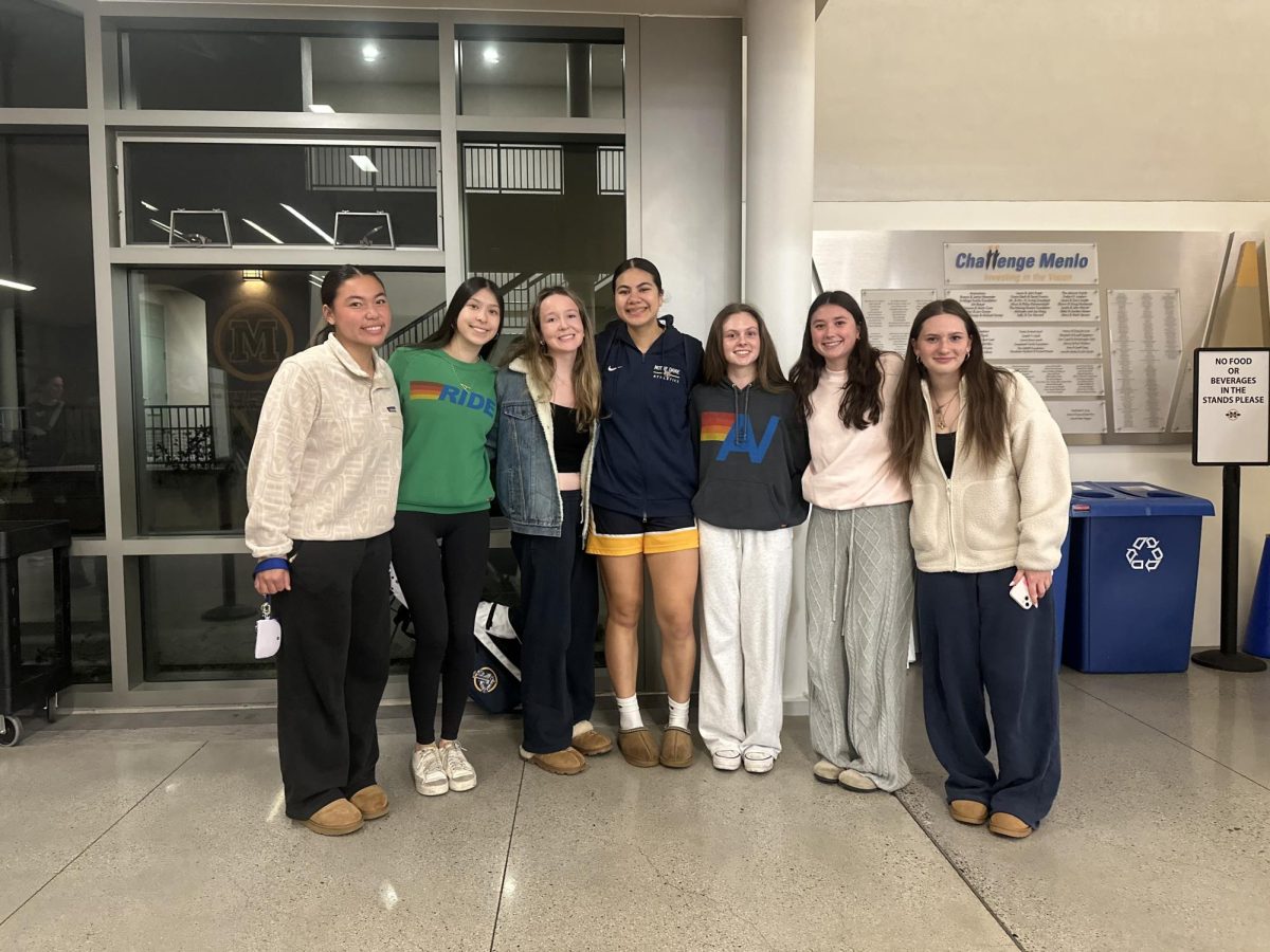 Junior Sammy Kakala (center) celebrates with friends after a recent game.