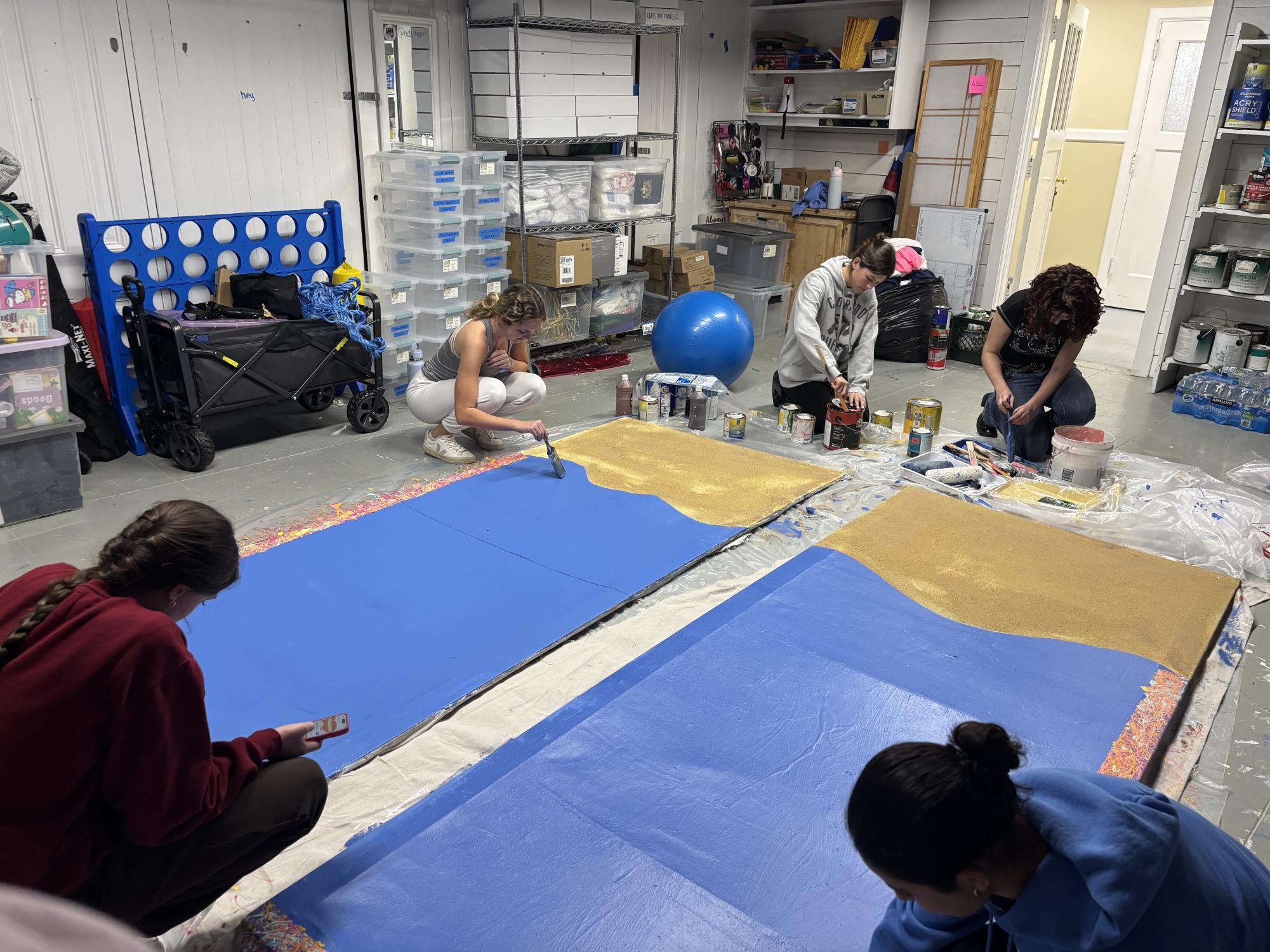 Seniors work on their class backdrop