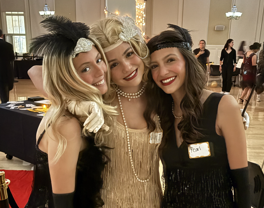 NDB juniors, dressed as Jazz Age flappers, pose for a photo. Many attendees opted to dress as flappers for the Gatsby Ball event.