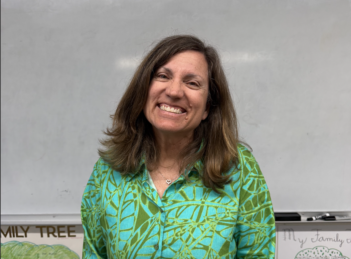 The swim coach, Wendy Connolly, has a goal to improve her athletes' swim time