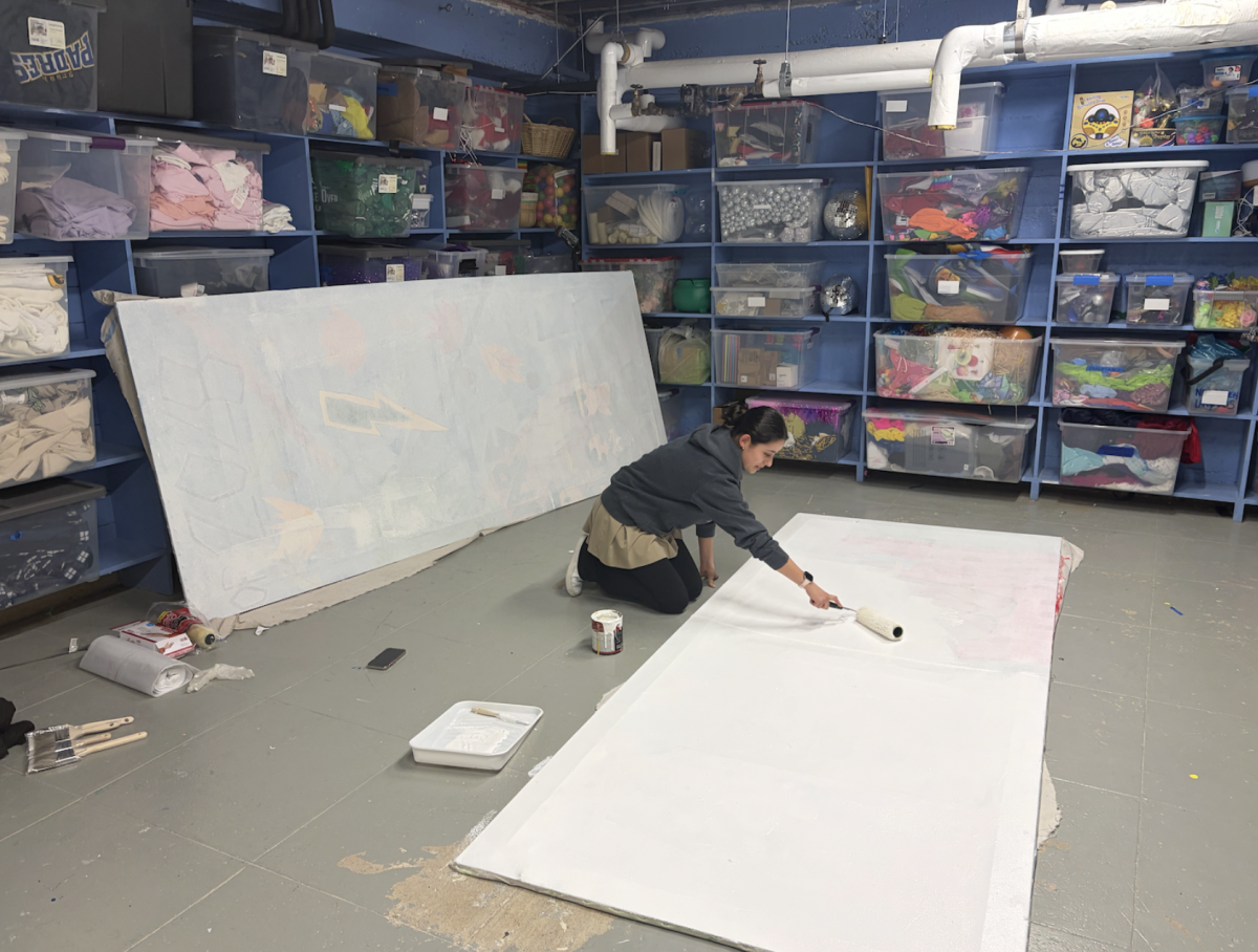 Senior Autumn Deetz-Rodriguez primes one panel of what will become the Aquacades backdrop for the Class of 2026.