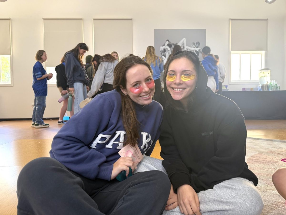 Seniors Page Krensavage and Juliette Ramirez relax in the spa room while applying eye masks. The activity offered students a chance to unwind and take a break from their usual routines.
