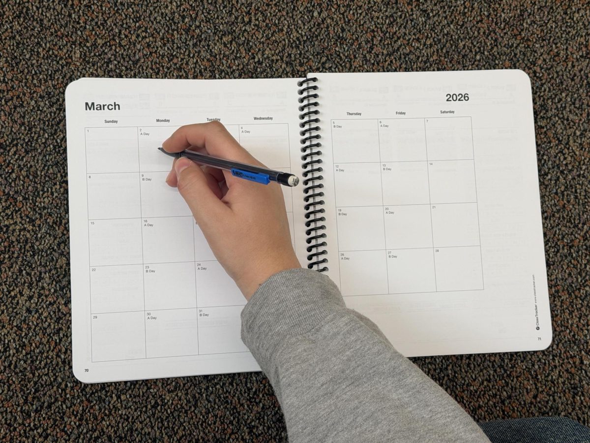 NDB student starts planning out her month in a planner.