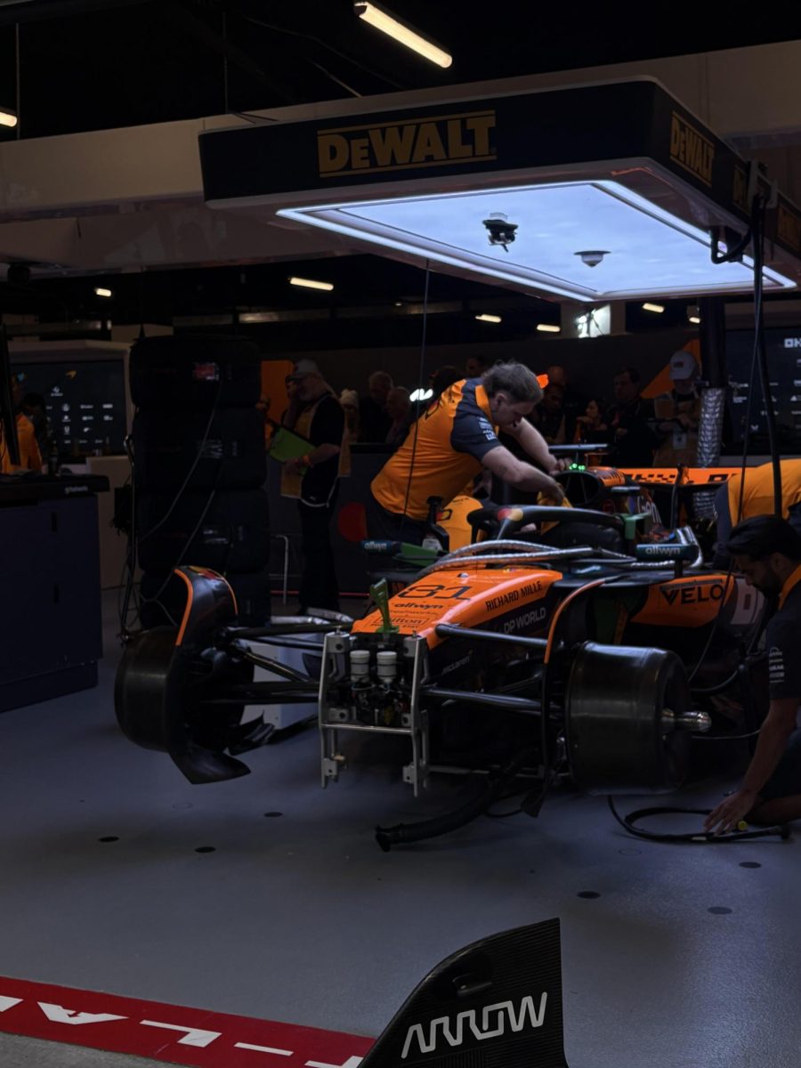 A tech works on a McLaren race car.