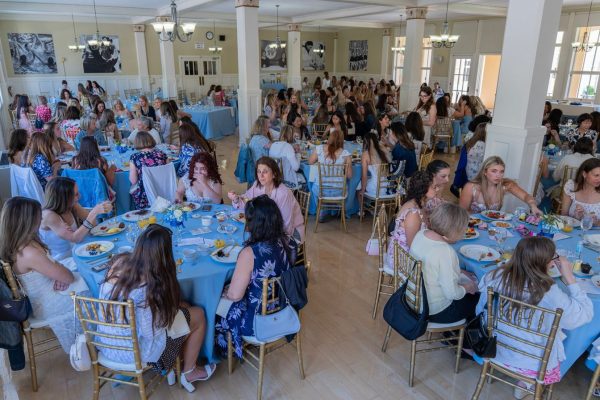 Mothers and their daughters sit down for a delicious brunch.